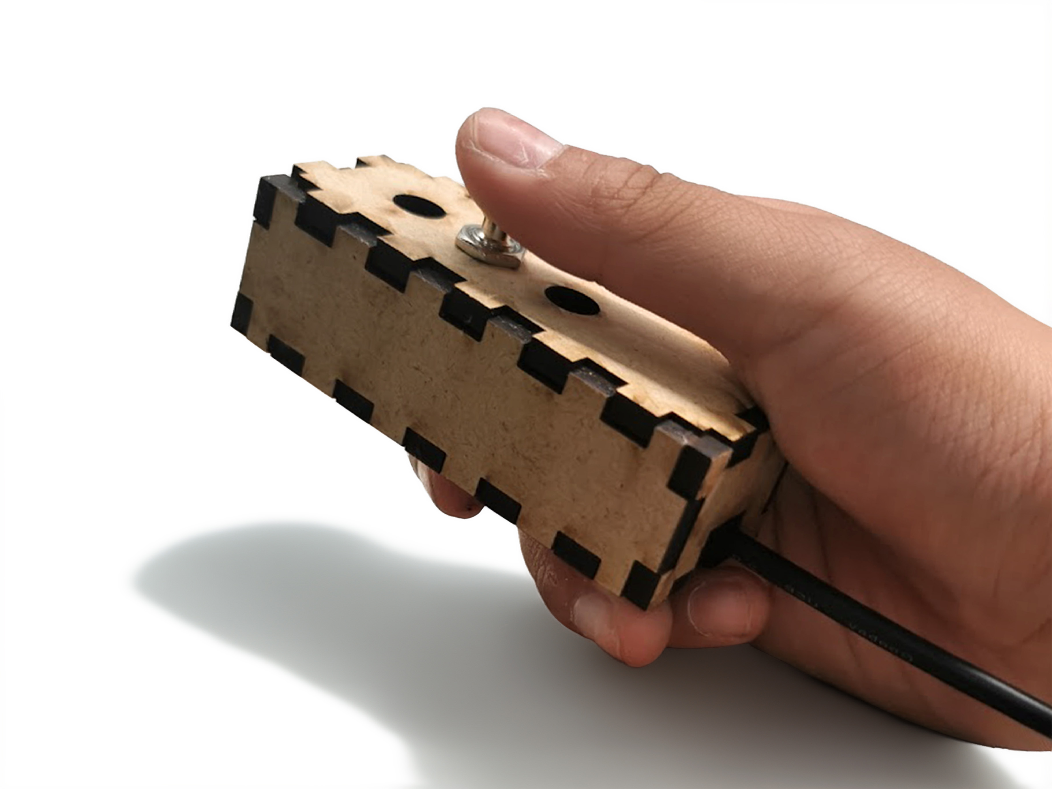 A compact wooden programmable keyboard held in one hand